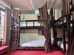 a room with three bunk beds in a hostel at Amlysa Sapa Hotel 2 in Sa Pa +15 photos