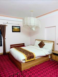 a bedroom with a bed and a chandelier at Amlysa Sapa Hotel 2 in Sa Pa