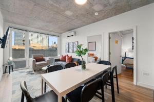 a dining room and living room with a table and chairs at Corporate-Friendly 4BR Stylish & Central in Chicago