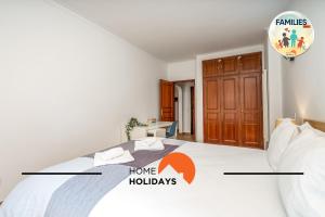 a bedroom with a bed with the words home holidays at #290 Families Only - Choro Azul by Home Holidays in Albufeira +38 photos