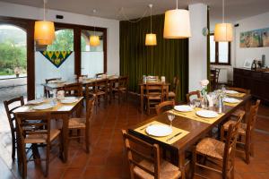 a dining room with wooden tables and chairs at La Locanda Cuccuini in Cavriglia