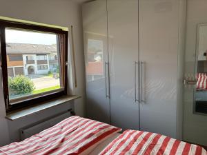 a bedroom with a bed and a window at Ruheoase Inzell in Inzell