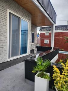 a house with a balcony with plants on it at Lucky House in Busan