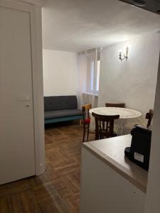 a living room with a couch and a table at Appartamento Camino in Ganna