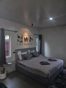 Ένα ή περισσότερα κρεβάτια σε δωμάτιο στο Tropical Hideaway Close to the Beach