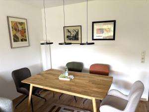 a dining room with a wooden table and chairs at Ruheoase Inzell in Inzell