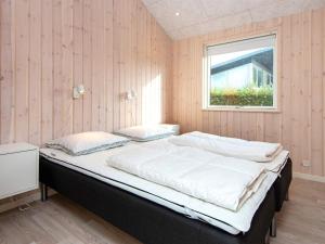 a large bed in a room with a window at Luxury Beach House with Spa - By Traum Ferienwohnungen in Børkop