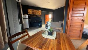 a kitchen with a wooden table with a potted plant on it at pousada calango in Canoa Quebrada