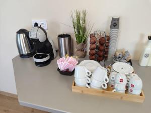 a counter with a tray of coffee cups and other items at Ubis Hotel in Krumovo