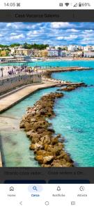 a view of a beach with rocks in the water at La casa nel borgo in Acaya