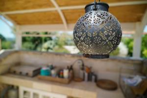 a black and silver light hanging over a kitchen counter at Le Comarelle - Country Rooms in Cisternino