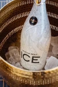 a bottle of wine sitting in a wicker basket at Elephant Luxury Penthouse in Prague +40 photos