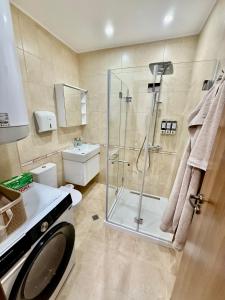 Un baño con ducha, inodoro y lavabo. en Beach Please Apartment, en Burgas