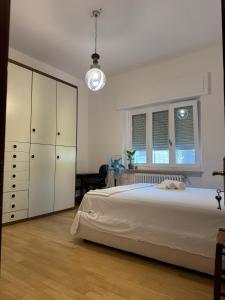 a bedroom with a large white bed and a window at La VILLA REGAL in Brescia +26 photos