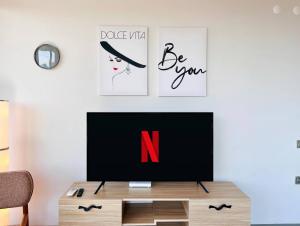 a living room with a tv on a table at ECB Flats Aksu in Aksu