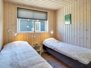 two beds in a room with a window at 5 star holiday home in Kappeln in Kappeln