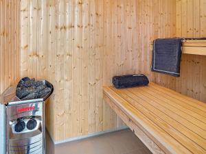 a sauna with a bench and a trash can at 5 star holiday home in Kappeln in Kappeln