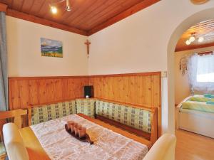 a dining room with a table and a bed at Apartment in Niedernsill near Ski Slopes in Niedernsill