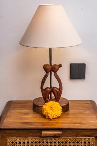 a table with a lamp on top of a table at Taman Kencana Ubud in Ubud