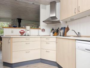 a kitchen with white cabinets and a sink at 8 person holiday home in Struer in Struer