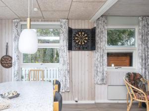 a dining room with a table and a dartboard on the wall at 8 person holiday home in Struer in Struer
