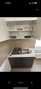 a kitchen with a sink and a counter top at Budget Rooms Köflach in Köflach +4 photos