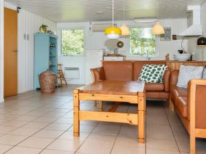 a living room with a couch and a table at 6 person holiday home in Ringkøbing in Ringkøbing