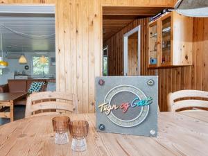 a wooden table with a sign on top of it at 6 person holiday home in Ringkøbing in Ringkøbing +30 photos