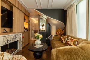 a living room with two couches and a fireplace at Royal Madeleine Hotel & Spa in Paris +106 photos