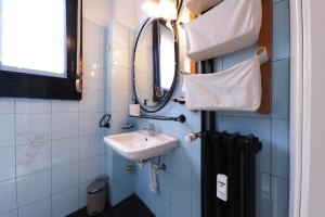 a bathroom with a sink and a mirror at PrimoPiano - Pacini in Milan +21 photos