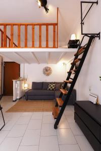 a living room with a spiral staircase in a loft at PrimoPiano - Pacini in Milan