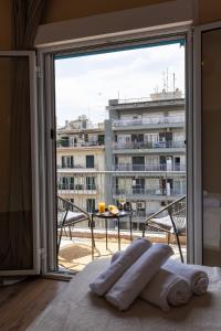 a bedroom with a large window with a view of a building at Boho style 2BD in Thessaloniki
