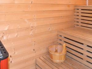 a wooden sauna with a bucket in the corner at 6 person holiday home in Bud in Bud