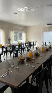 a large wooden table with utensils on top of it at Hotel BIOCERRO in Tandil