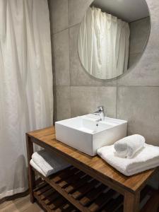 a bathroom with a white sink and a mirror at Hotel BIOCERRO in Tandil