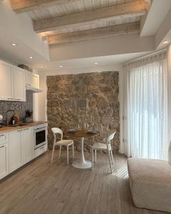 a kitchen and dining room with a table and chairs at Calèma Apartments in Villasimius