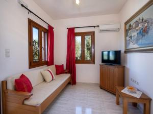 a living room with a couch and a tv at Villa in Crete near Beach and Olive Groves in Pangalochori