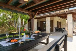 a wooden table with wine glasses on a patio at Villa Forte in Porat +20 photos