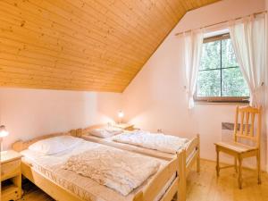a bedroom with a bed and a wooden ceiling at Holiday Home in Javorník near Krkonose Park in Rudník