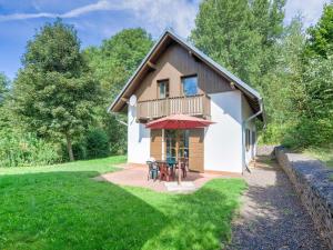 a house with a balcony and tables in the yard at Holiday Home in Javorník near Krkonose Park in Rudník
