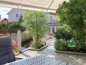 a patio with trees and plants on a balcony at 7 person holiday home in STRöMSTAD in Strömstad