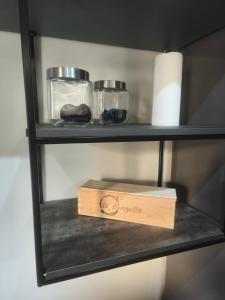 a shelf with a box and a roll of paper towels at Apartamento Vermú in Guadix