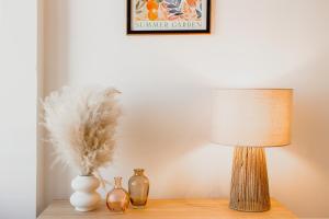 a table with a lamp and vases on it at Sainte-Cécile in Marseille