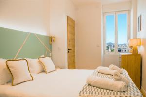 a bedroom with a white bed with towels on it at Sainte-Cécile in Marseille +53 photos