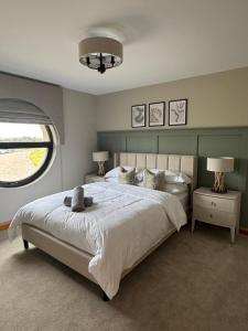 a bedroom with a bed with a stuffed animal on it at Beachhaven Rossnowlagh in Rossnowlagh