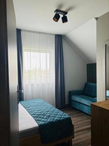 a small bedroom with a bed and a couch at Chill Out Rewal House in Rewal