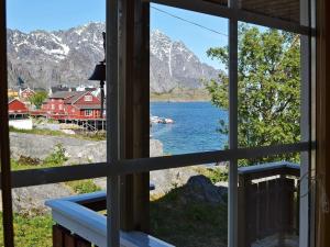a view from a window of a lake and mountains at 3 person holiday home in Henningsvær in Henningsvær