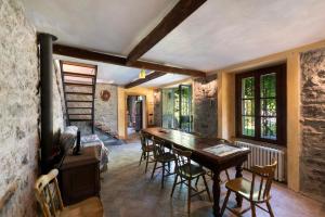 a dining room with a wooden table and chairs at Casale La Selva Cottege grande in Piano Porlezza