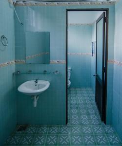 a bathroom with a sink and a toilet at Thuy Loi Hotel in Hoi An