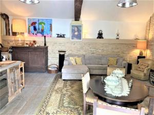 a living room with a couch and a table at Cottage in Saint-Jean with Terrace in Frontenay-sur-Dive